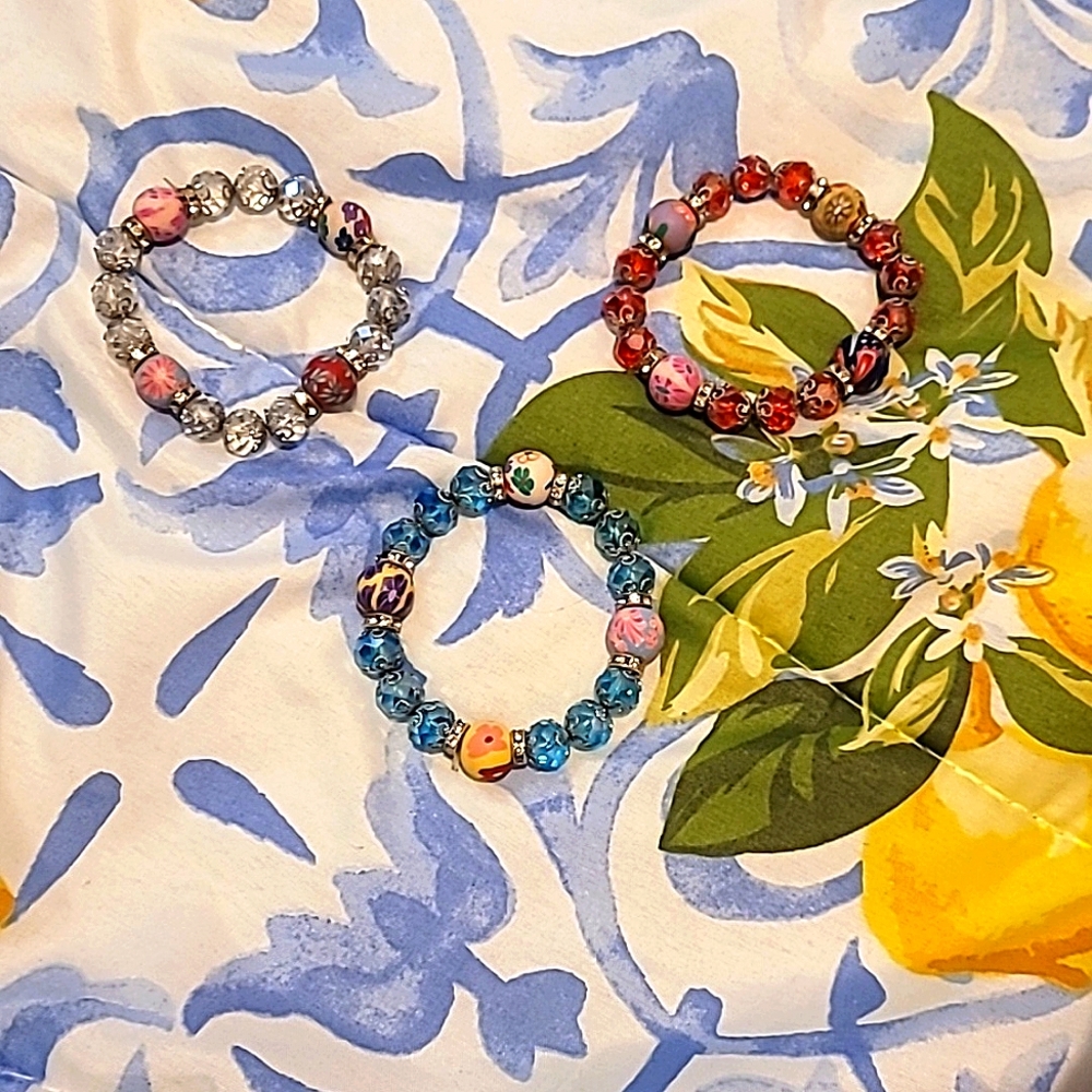 BRAND NEW! Without tags. Women's blue, red, and clear/silver bracelets.